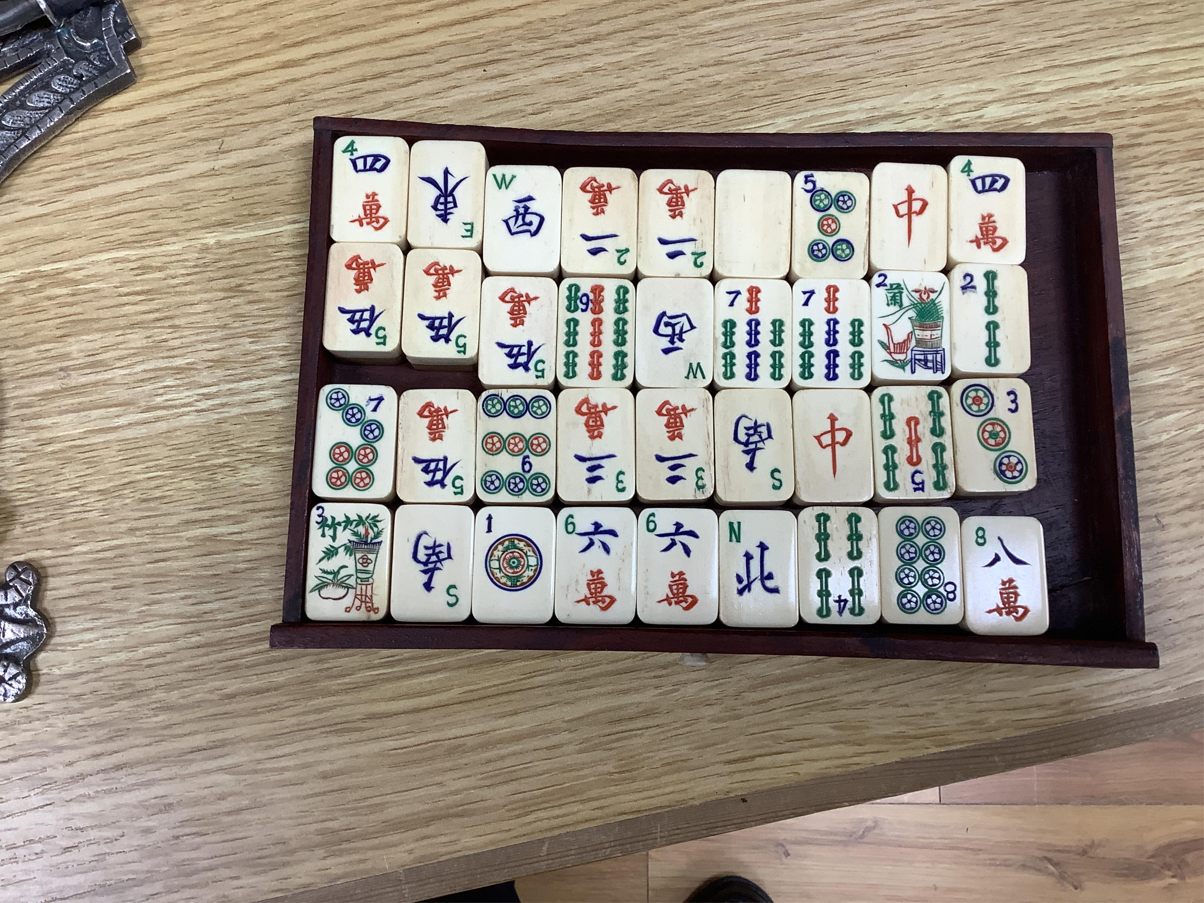 An early 20th century Chinese Mah Jong set, with bone tiles, 22cm x 15.5cm x 14.5cm. Condition - fair, one drawer front replaced